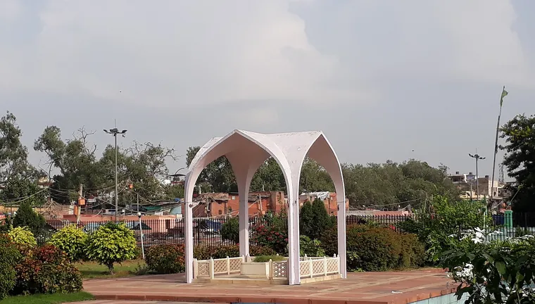 The white arched canopy over the tomb of Maulana Abul Kalam Azad in a landscaped enclosure in Old Delhi.