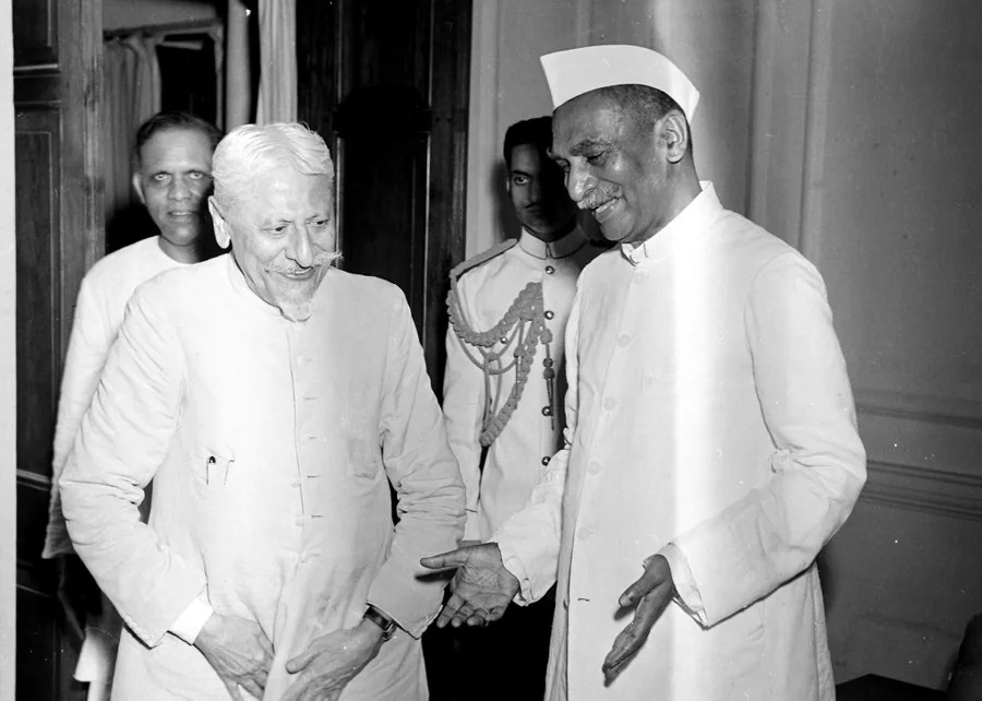 Maulana Abul Kalam Azad in conversation with Dr Rajendra Prasad, both smiling, photographed indoors.
