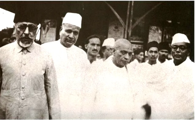 Congress leaders walking together; Maulana Abul Kalam Azad at the left in spectacles.